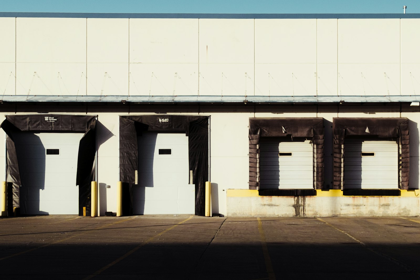 Loading dock bays with white roll-up doors