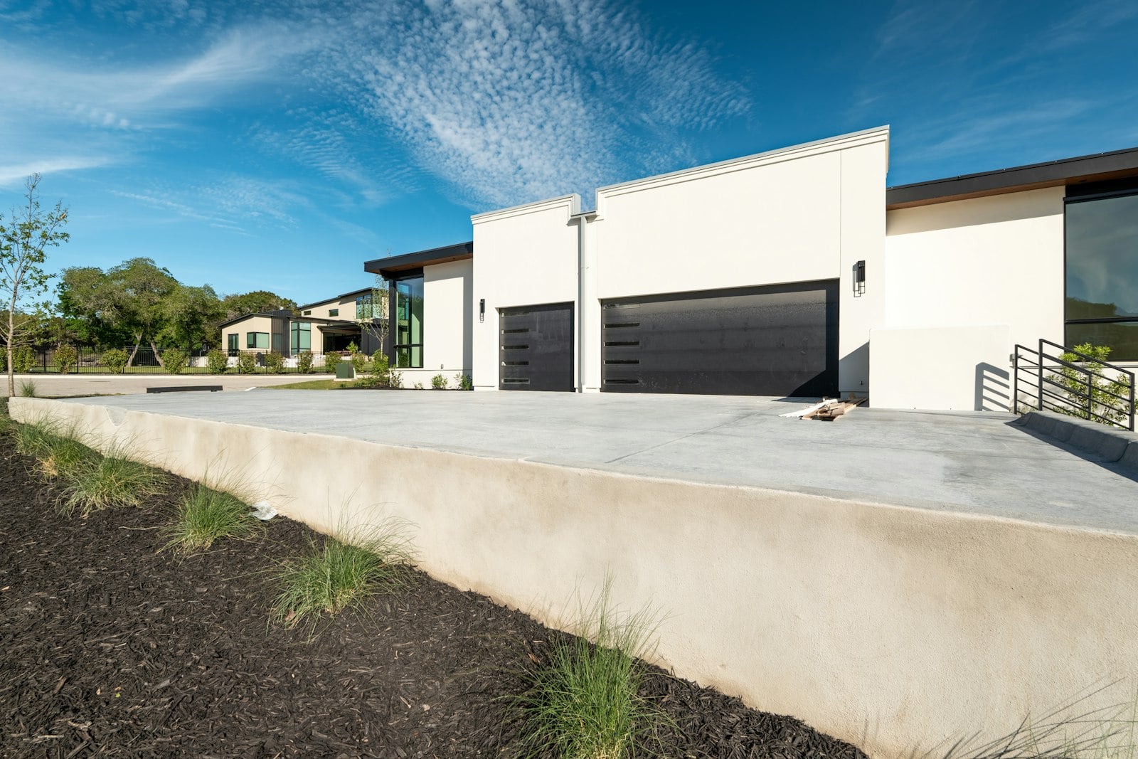 Black sectional garage doors on a modern house