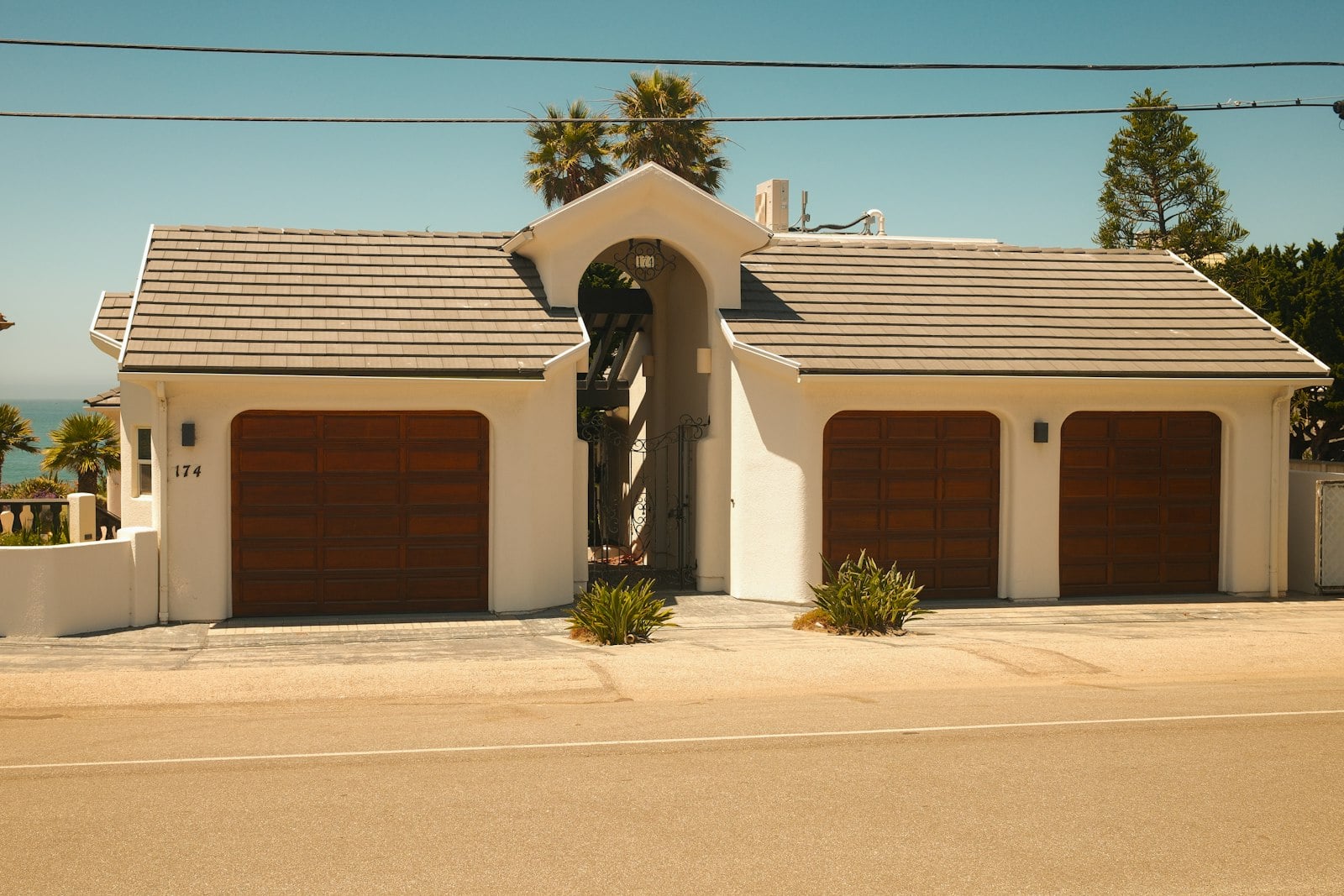 Home with three wooden garage doors side by side